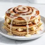 fluffy cinnamon roll pancakes with cream cheese frosting - featured image